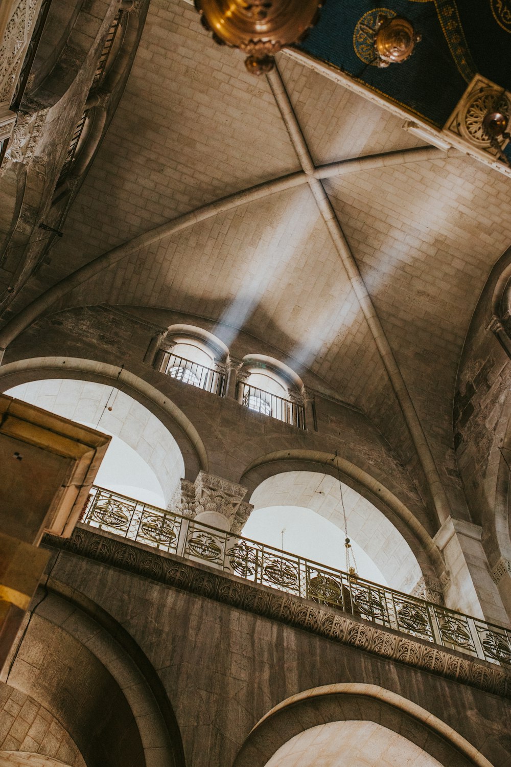 the ceiling of a large building with many windows