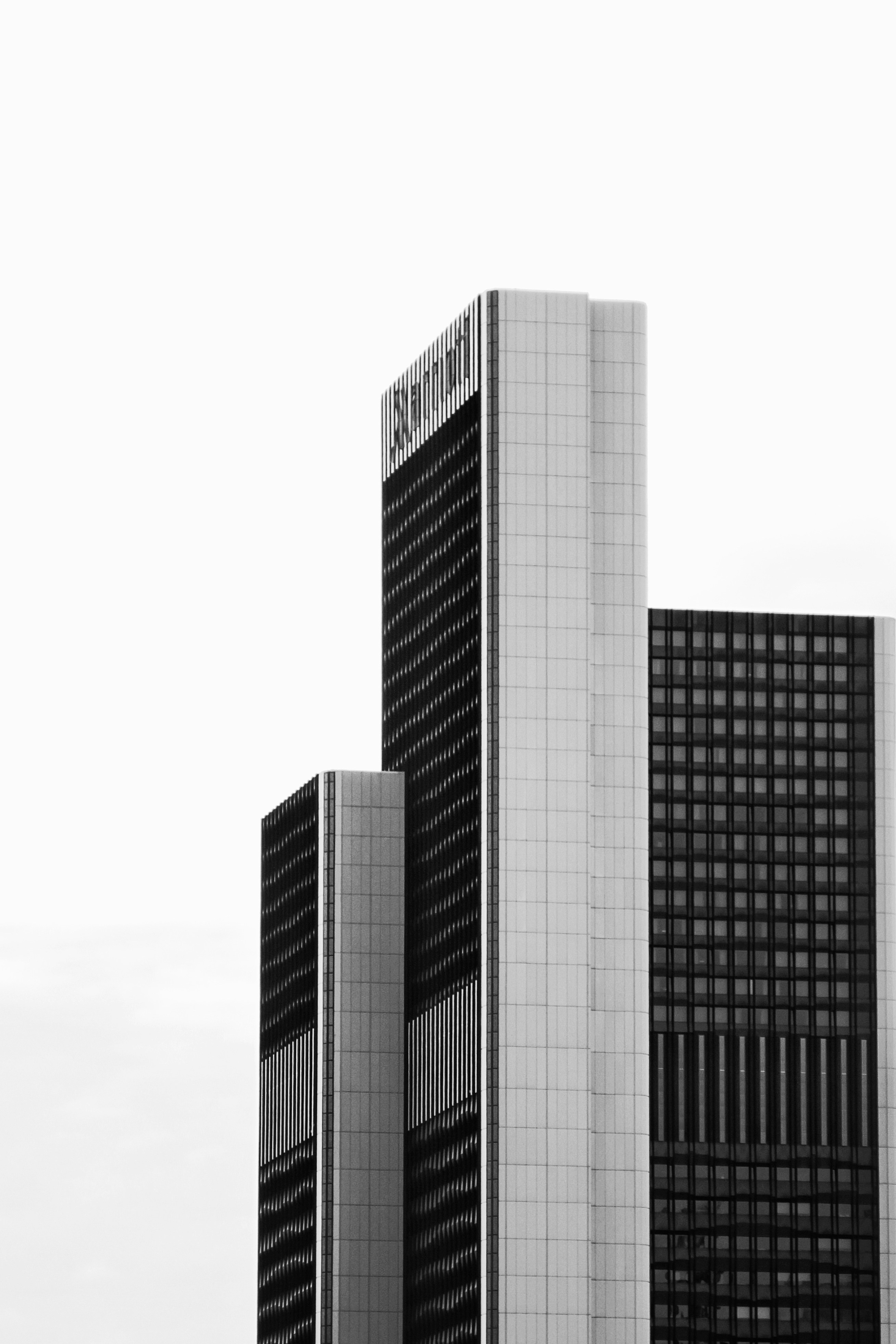 a black and white photo of two tall buildings