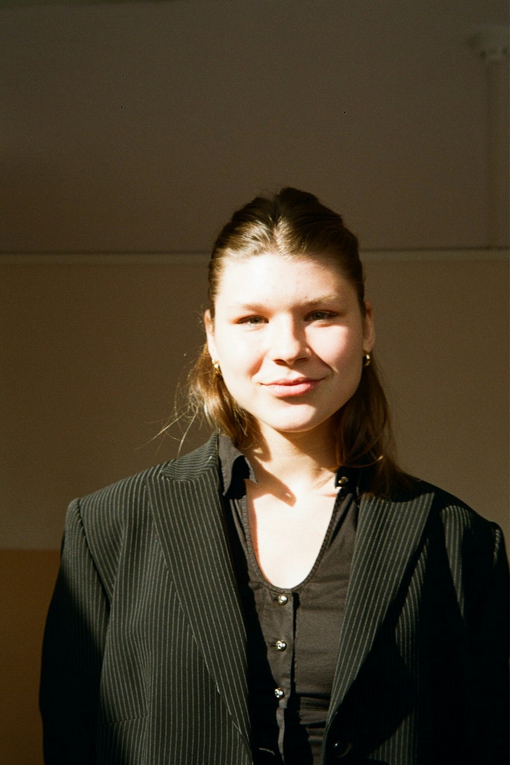 a woman in a suit posing for a picture