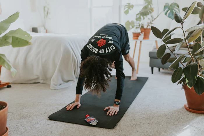 A woman holding a yoga pose on a mat