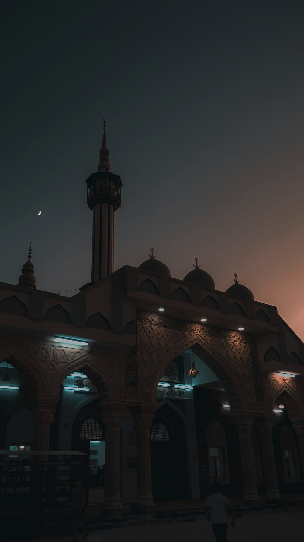 a large building with a clock tower at night