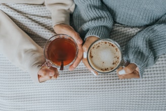 two people having tea/coffee in bed