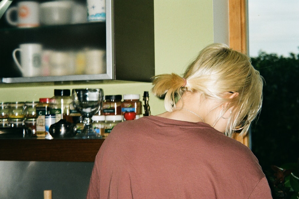 a woman standing in front of a kitchen counter