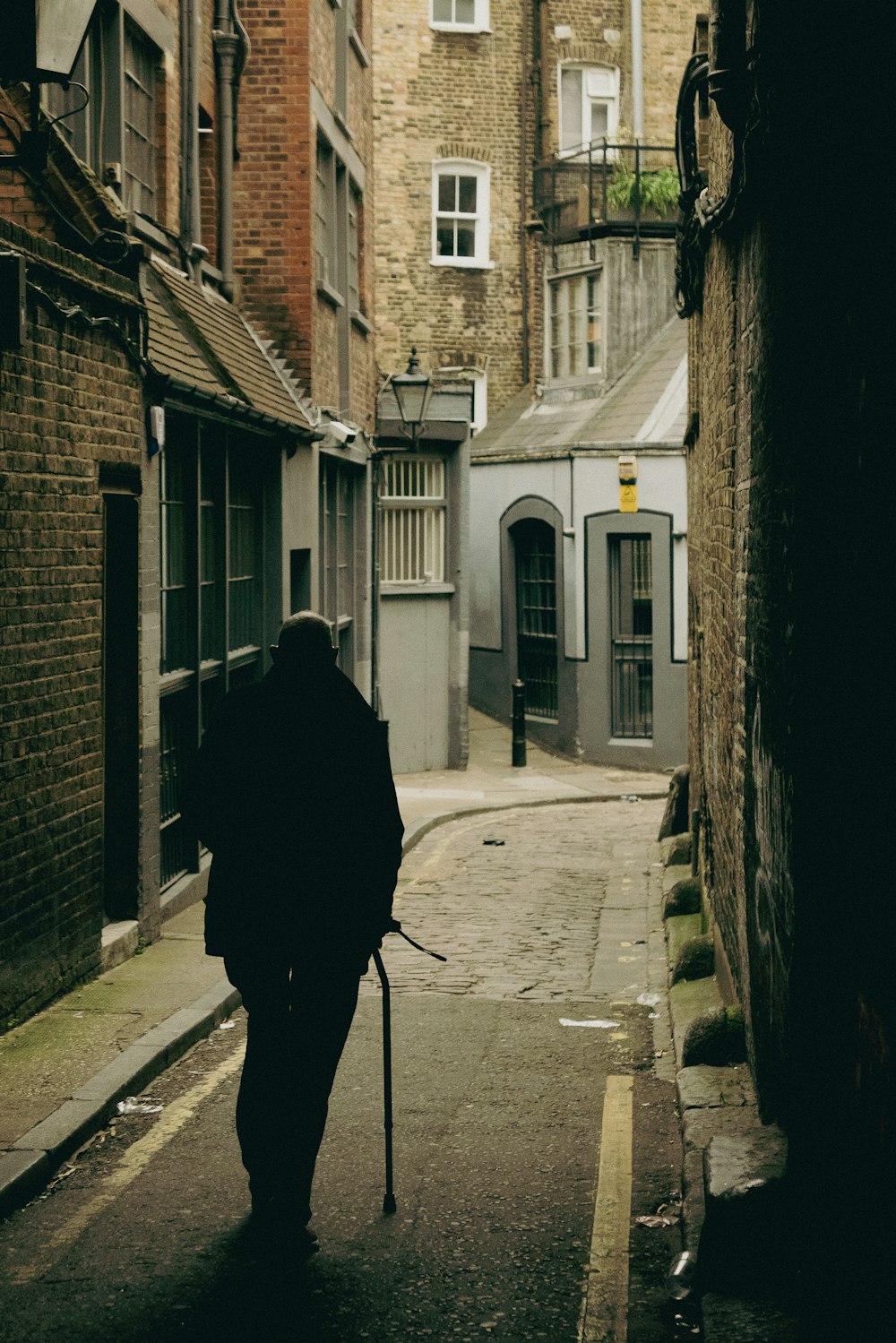 a person walking down a narrow alley way