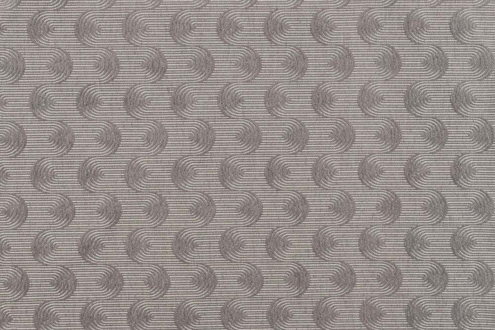 a gray and white rug with circles on it