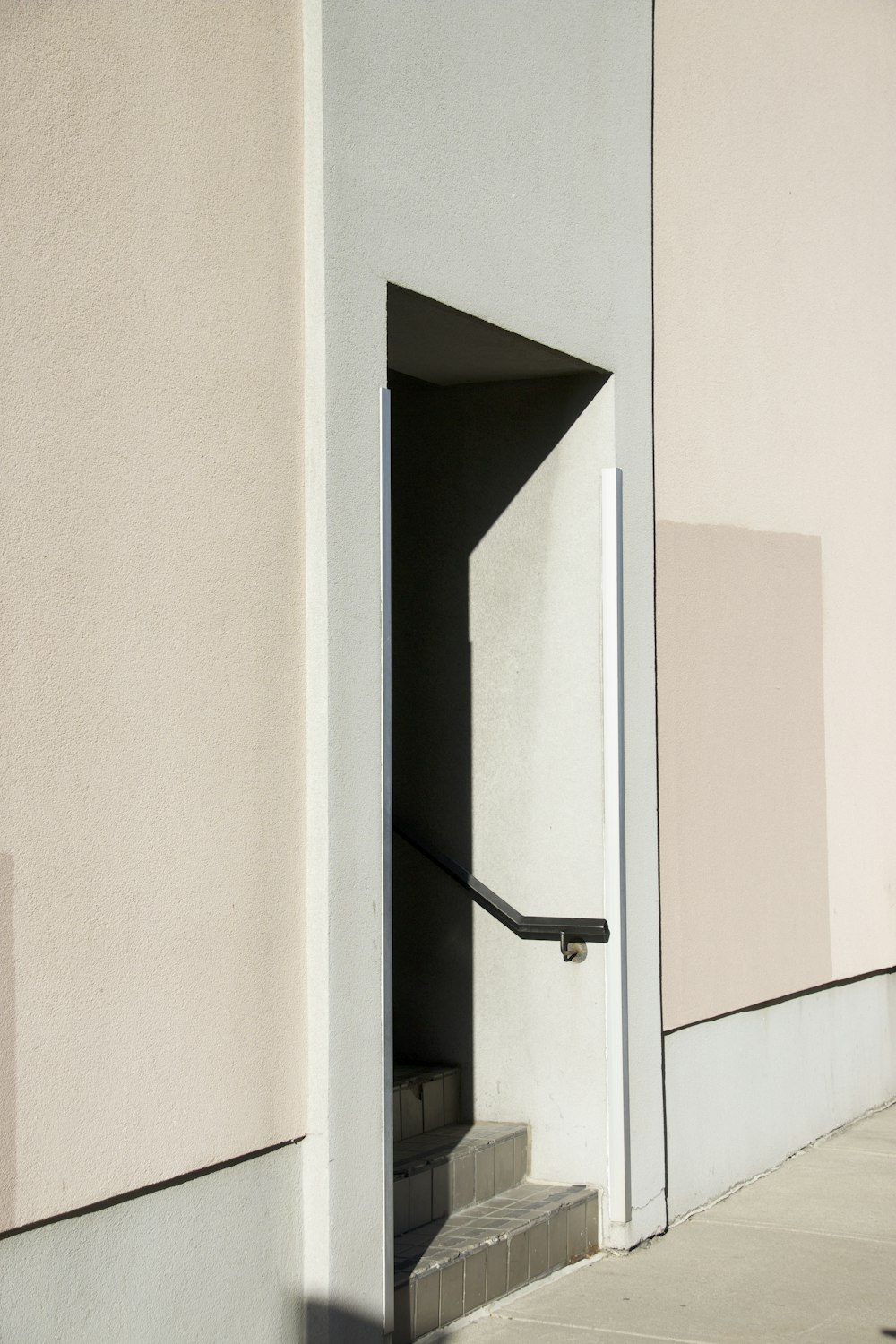 a white building with a black door and some steps