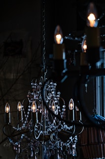 a chandelier hanging from a ceiling in a dark room