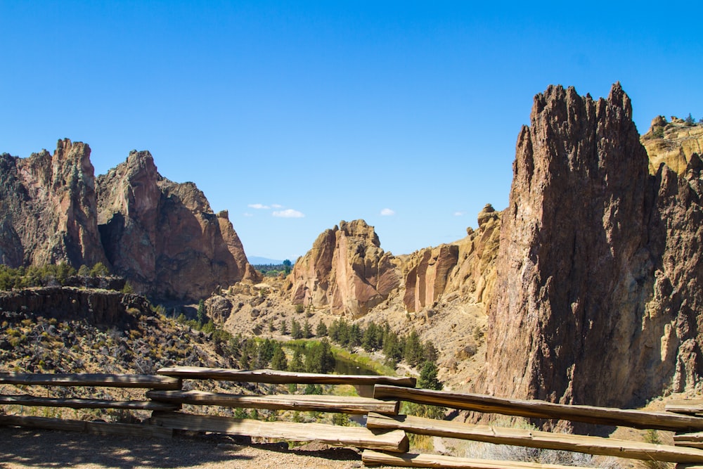 a wooden bench sitting on top of a mountain