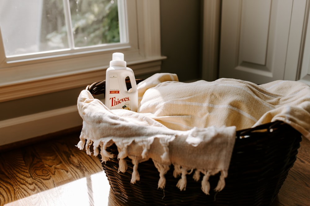 a bottle of deodorant sitting on top of a blanket