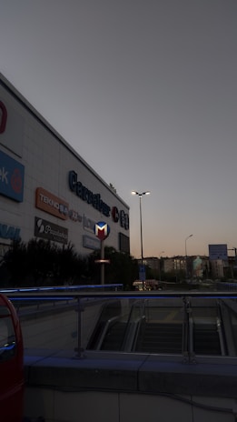 A vibrant exterior view of First Point Mall at sunset, showcasing its modern architecture.