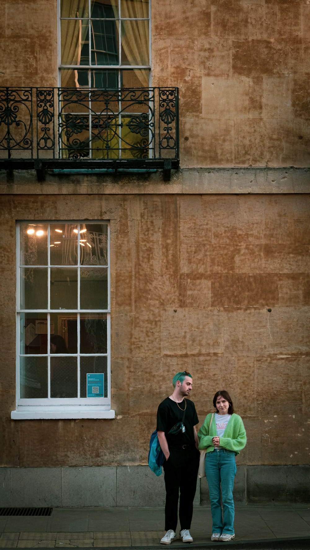 a couple of people standing in front of a building