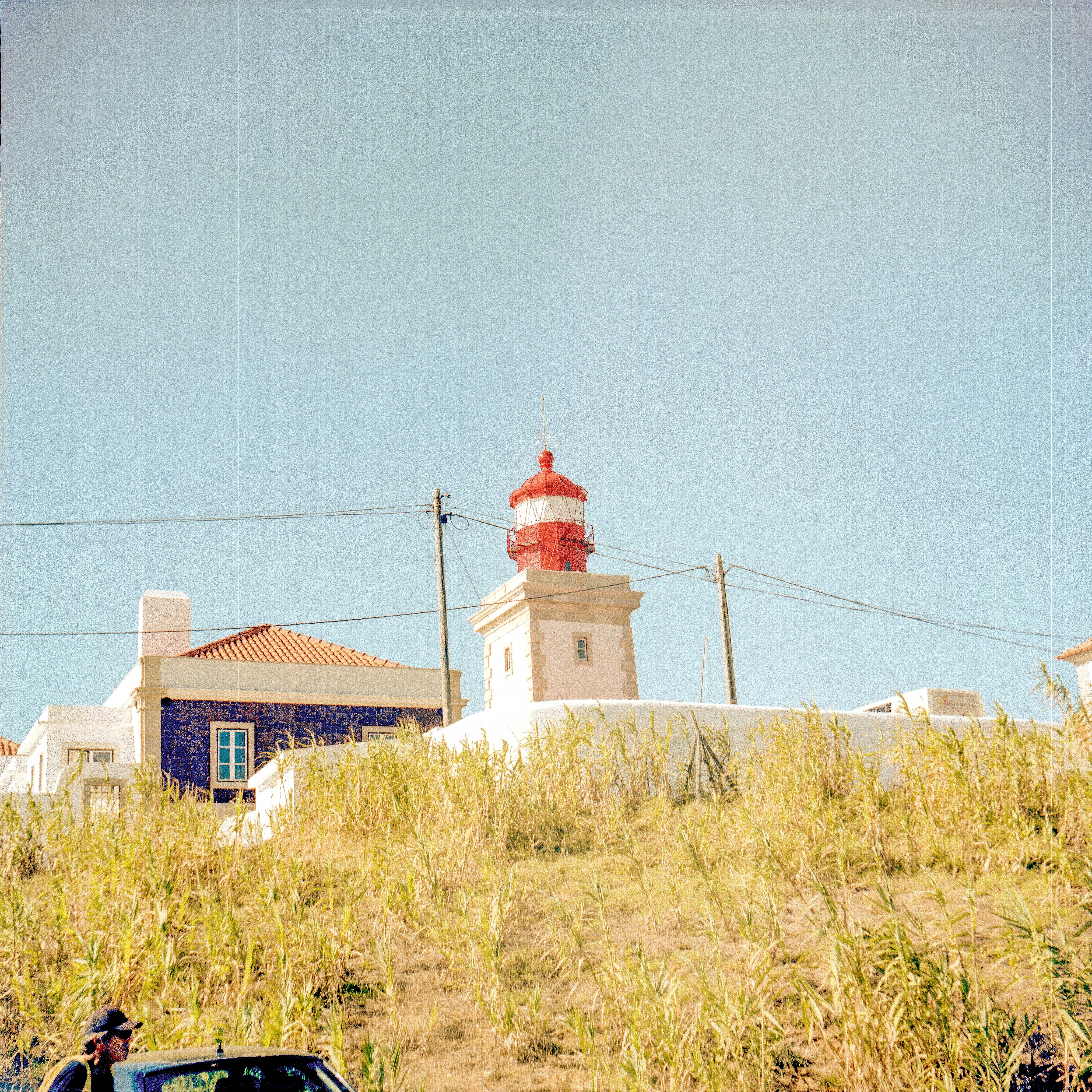 a car parked in front of a light house