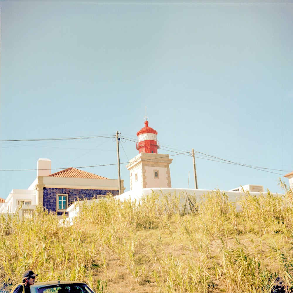 a car parked in front of a light house