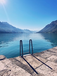 a body of water with mountains in the background