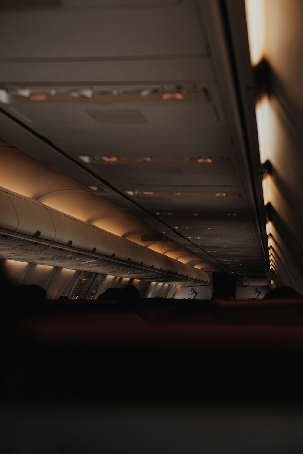 the inside of an airplane with the lights on