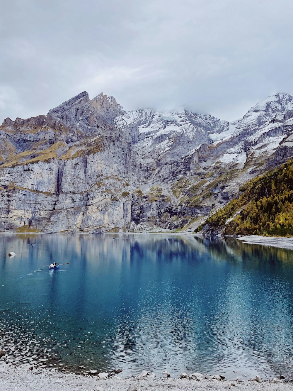 a body of water surrounded by mountains and trees