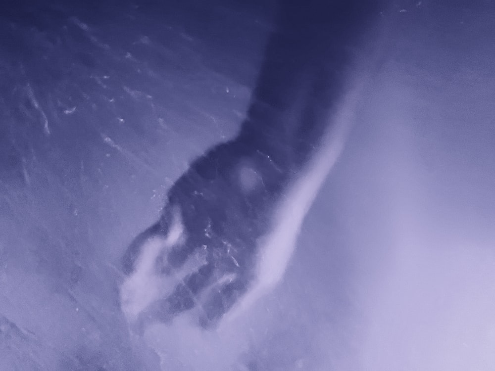 a snowboarder riding down a snow covered slope