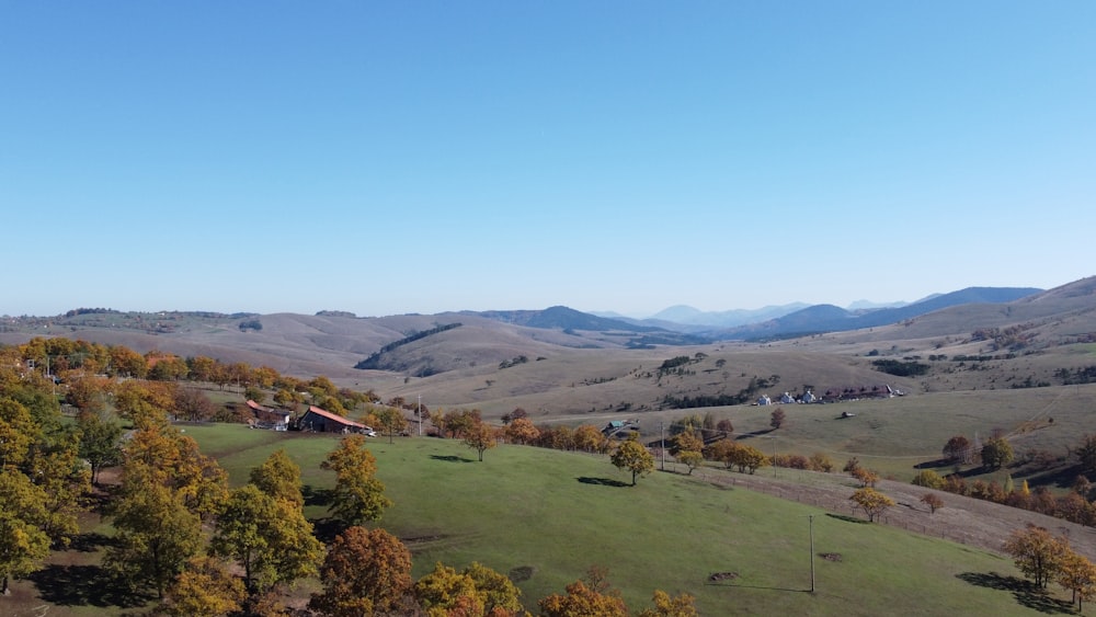 a view of a valley with a house in the distance