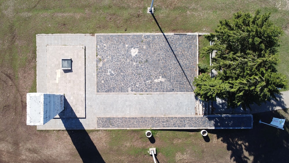 an aerial view of a building with a tree in the foreground