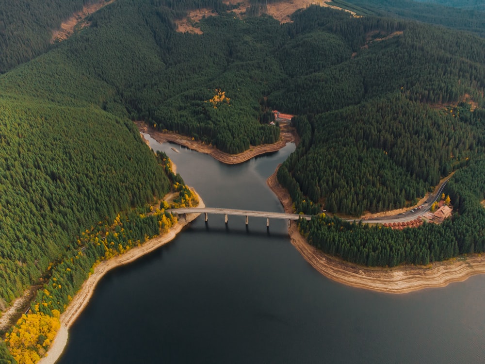 an aerial view of a bridge over a lake