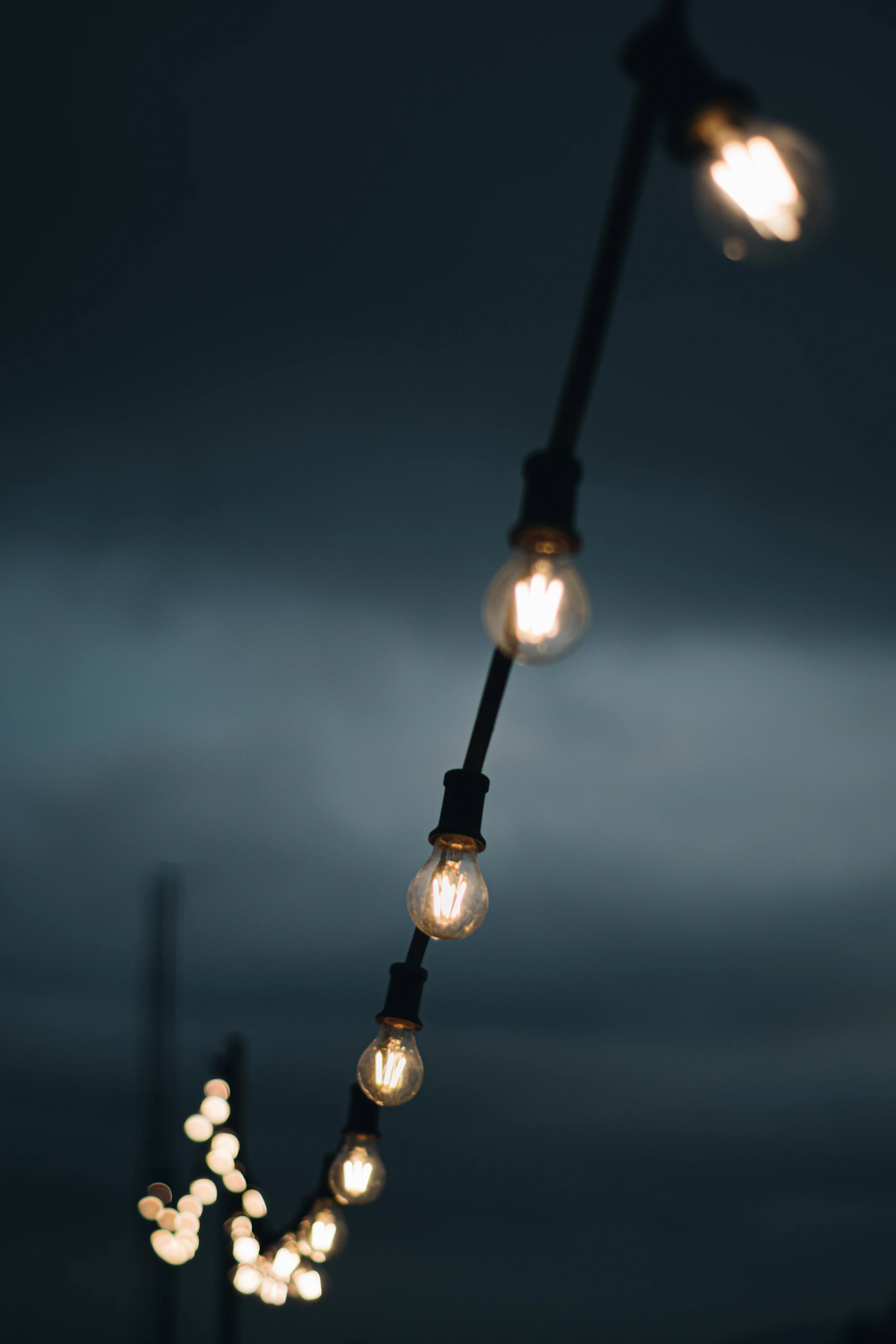 Stage lighting fixtures clamped to a pole before being rigged for a show