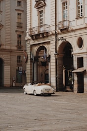a white car parked in front of a building