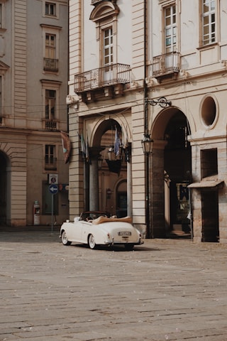 a white car parked in front of a building
