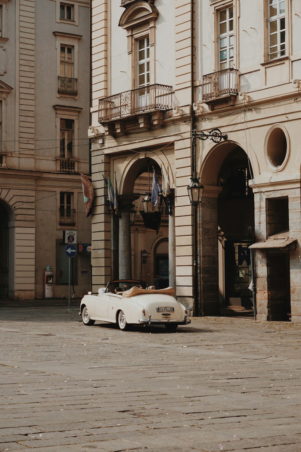 a white car parked in front of a building