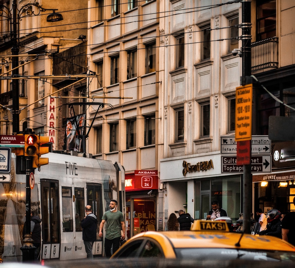 a city street filled with traffic next to tall buildings