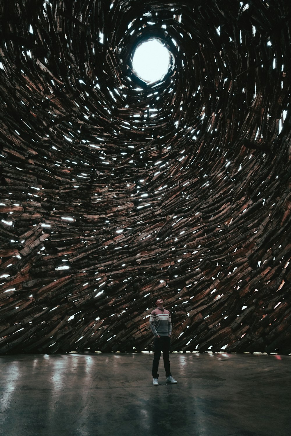 a person standing in front of a large sculpture