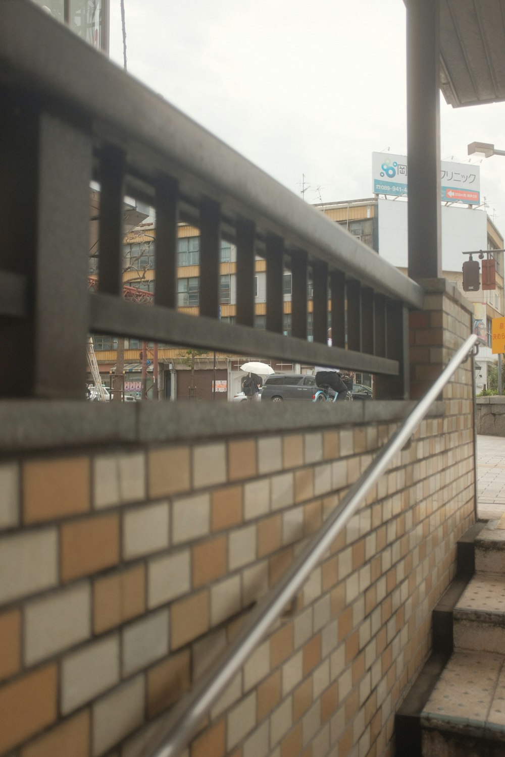 a brick wall with a metal hand rail