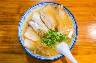 a bowl of soup with meat and vegetables