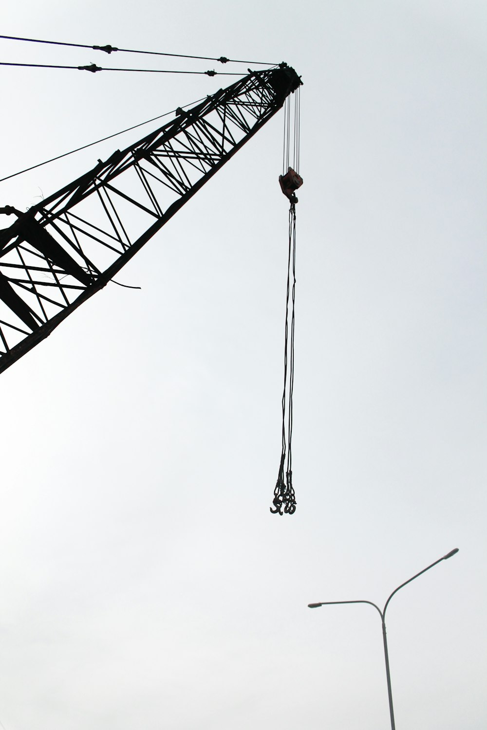 a crane that is hanging from a wire