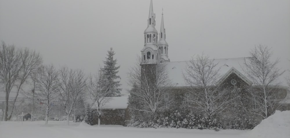 a church with a steeple covered in snow