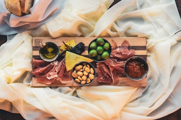 Assortment of party savory snacks arranged on a rustic wooden board