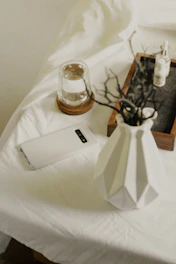 Close-up of sleek branded microfibre cloths and mobile stands arranged neatly on a clean white surface.