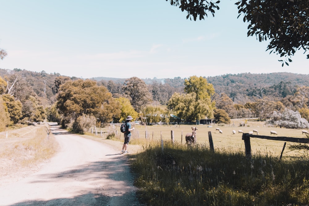 a man riding a skateboard down a dirt road