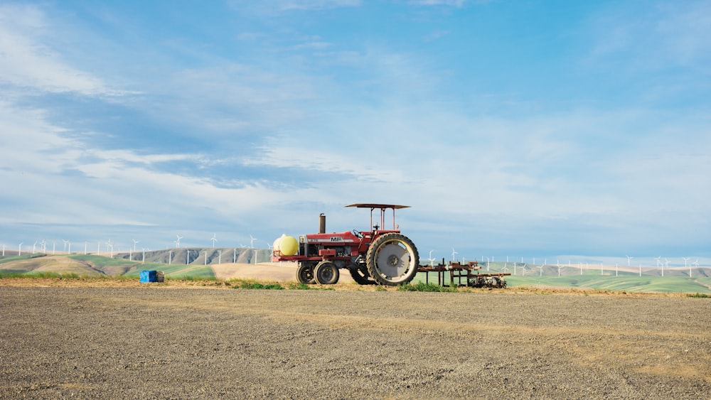 a tractor parked in a field with a blue sky in the background