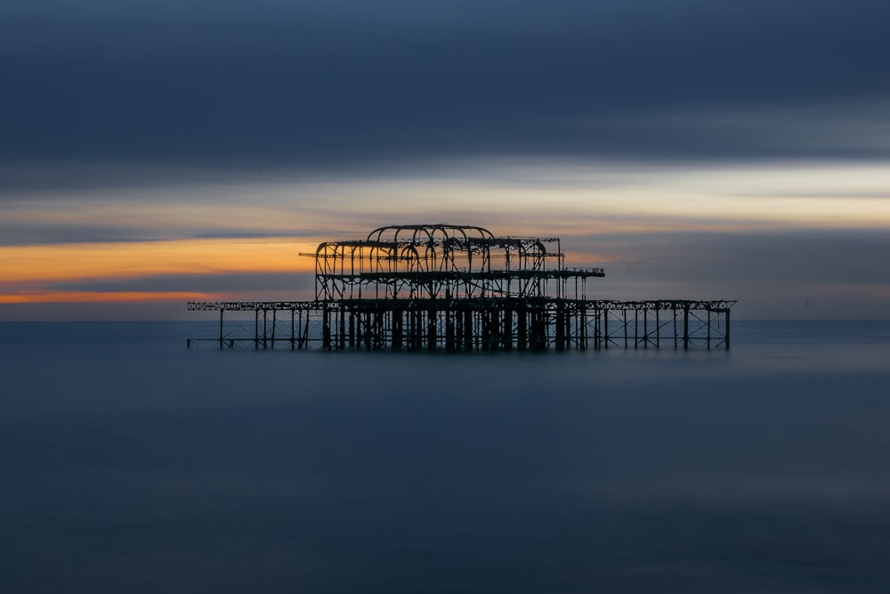 a structure sitting in the middle of a body of water