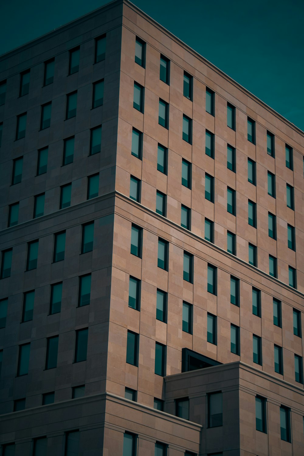 a tall building with lots of windows next to a street sign