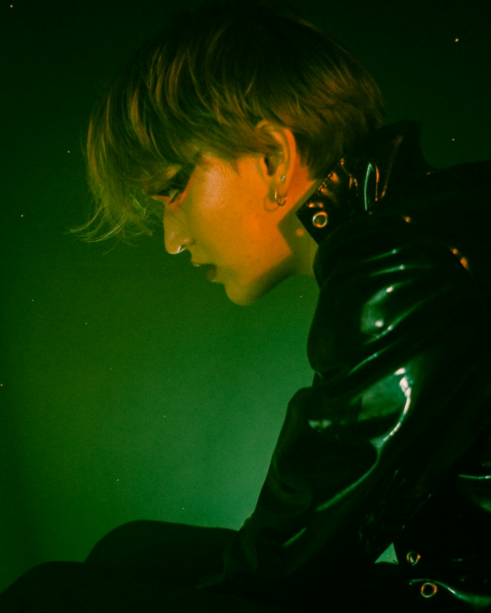 a woman in a black leather jacket sitting down