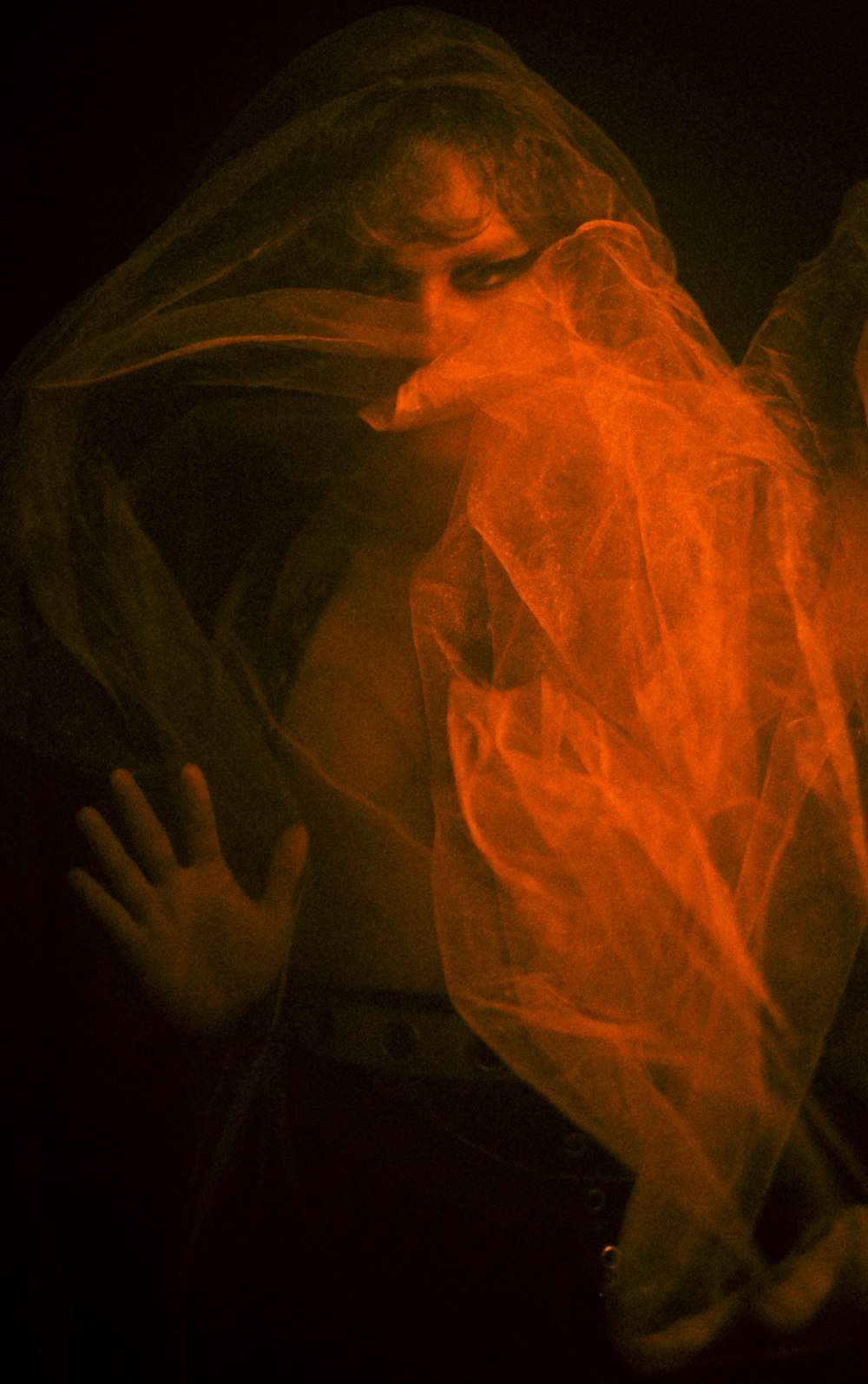 a woman wrapped in a plastic bag in the dark
