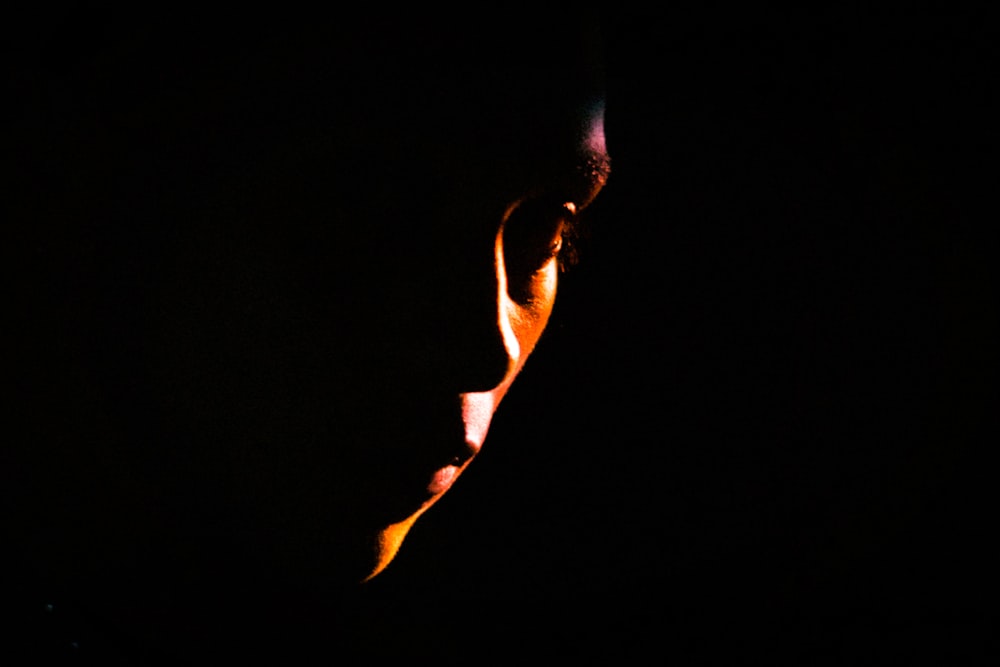 a close up of a person's face in the dark