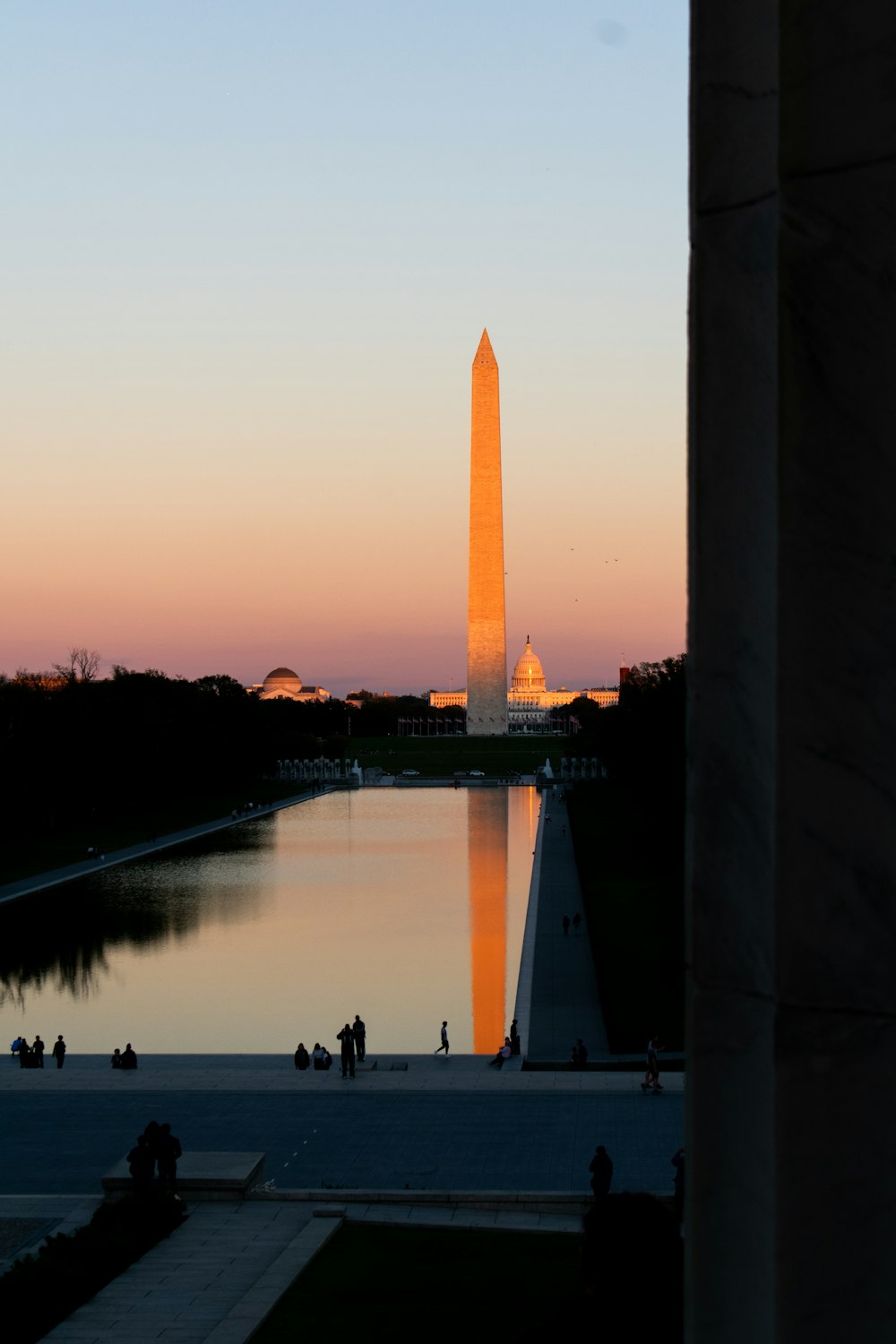 a view of the washington monument from across the reflecting pool