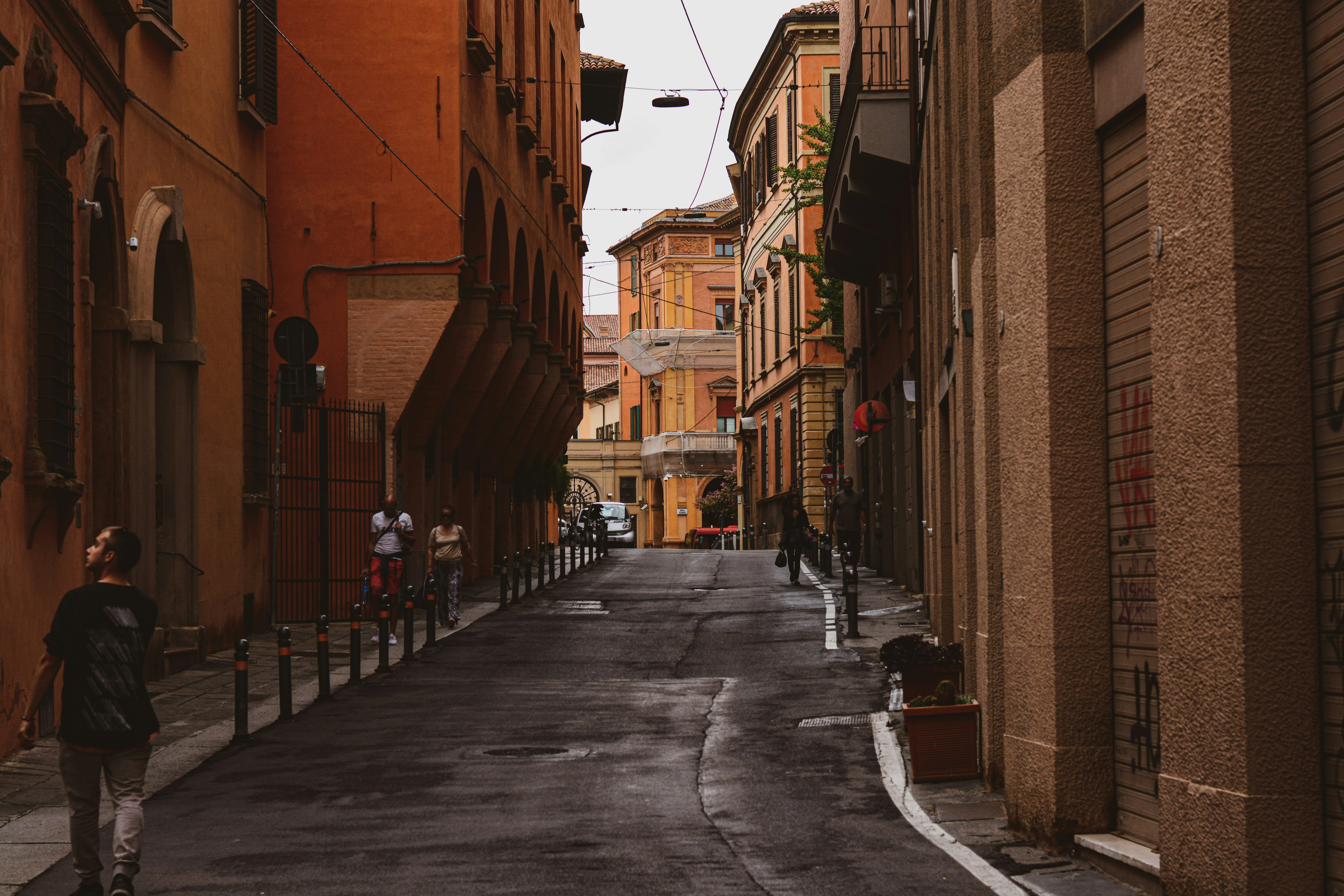 a man riding a skateboard down a street next to tall buildings