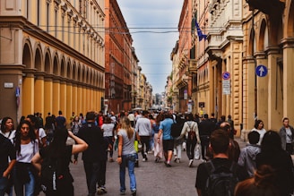 A bustling city street with historic buildings and lively crowds.