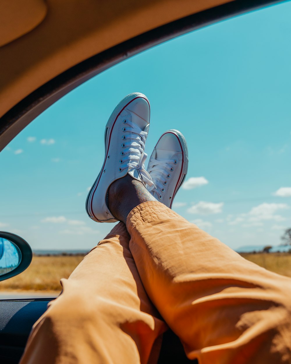 a person sitting in a car with their feet up