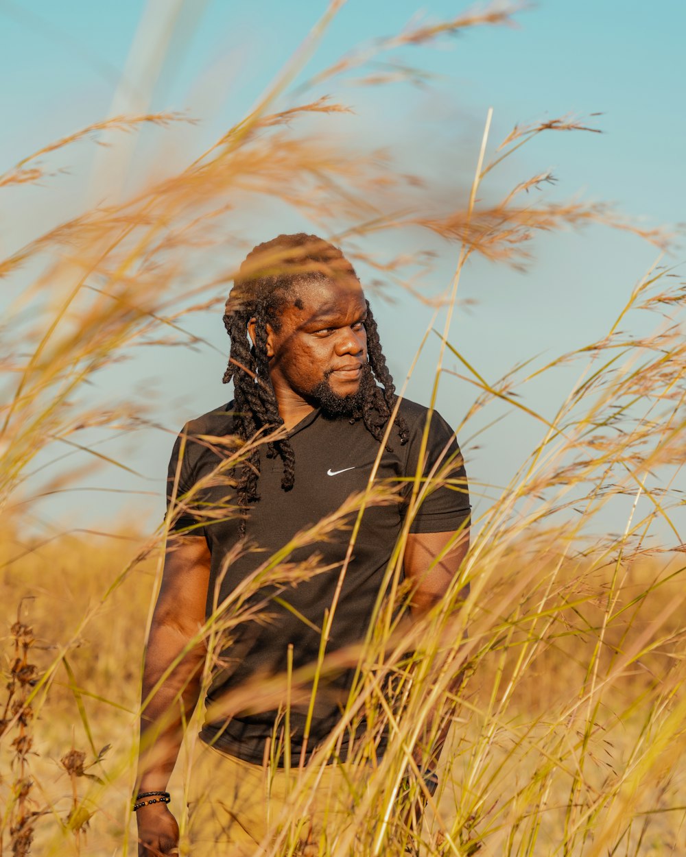 a man standing in a field of tall grass