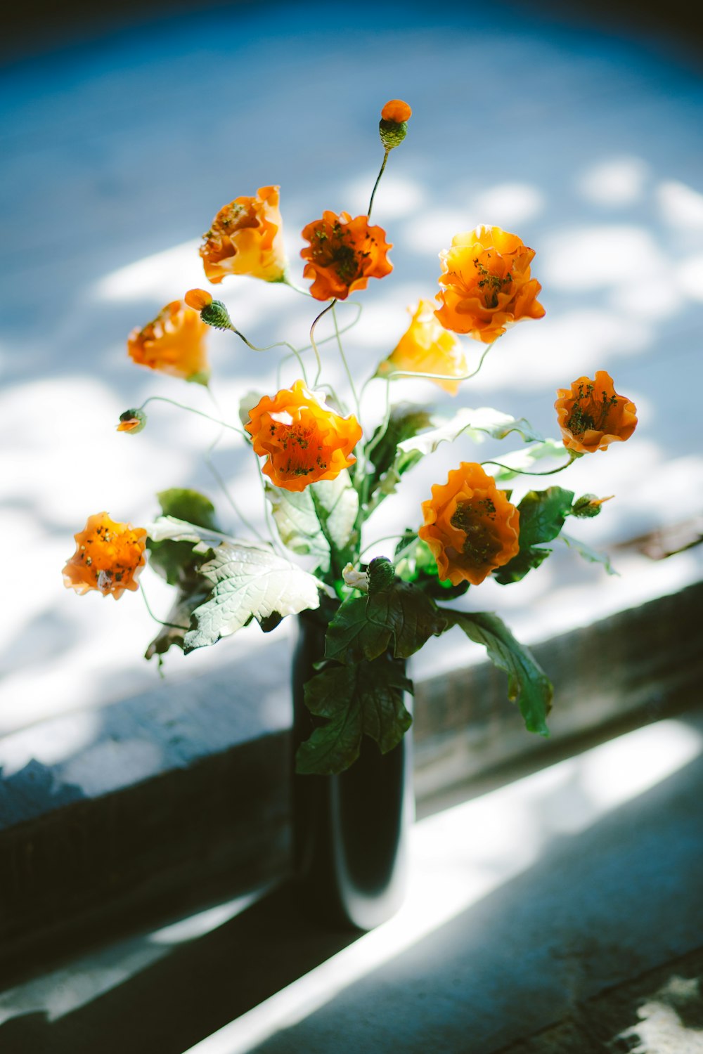 a vase filled with orange and white flowers