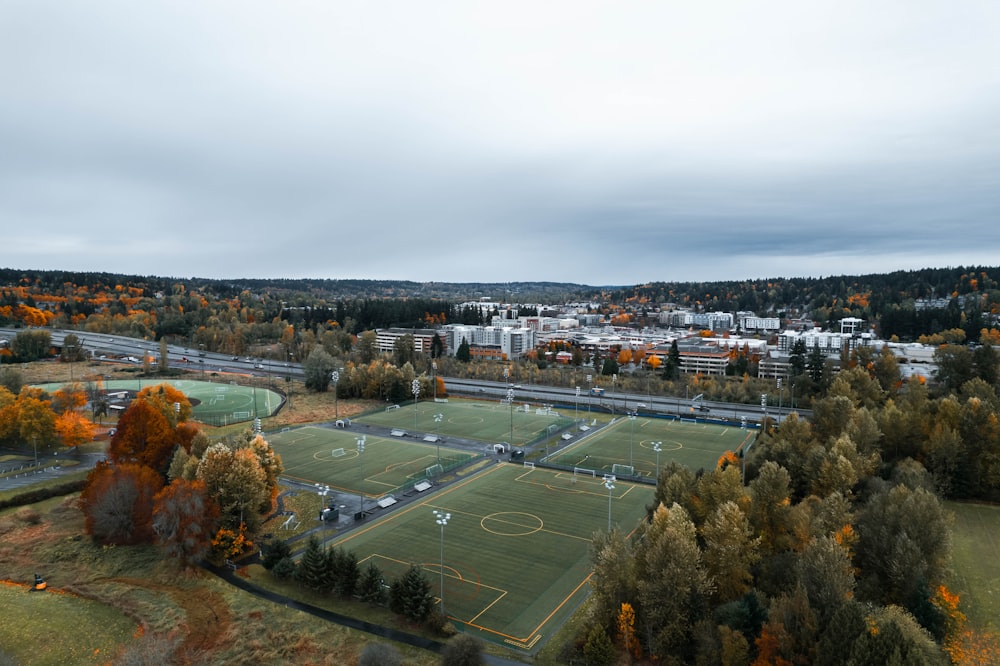 an aerial view of a soccer field surrounded by trees